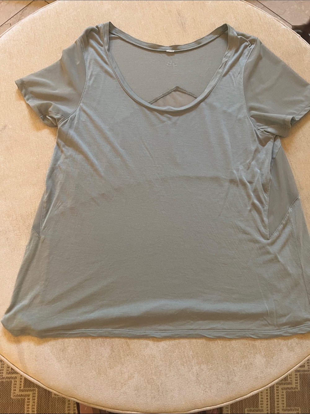 ALO Yoga Sage Green Short-Sleeve Scoop Neck Tee with sheer side panels.